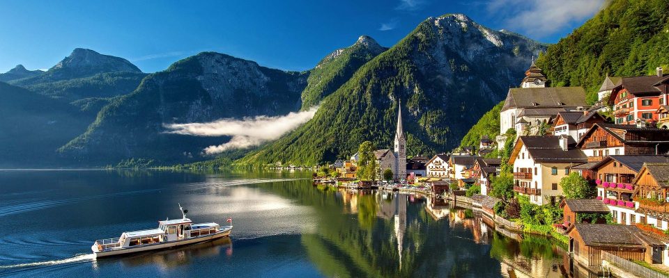Austrian lake with a boat and a mountainous background