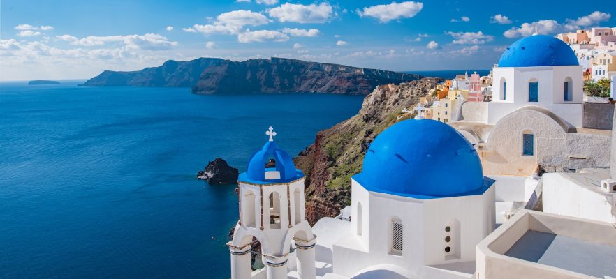 A lake and white buildings in Santorini, Greece