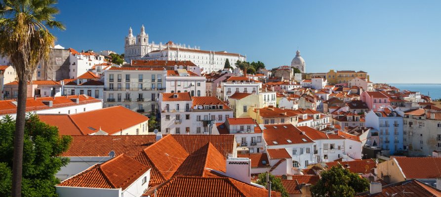City in Portugal with white buildings, orange roofs and blue sky